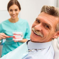 Smiling senior man at dental office