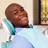 man smiles after getting dental implants in La Porte