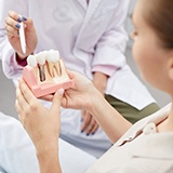 Woman learning about dental implant surgery in La Porte