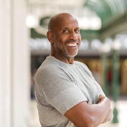 man with dentures in La Porte standing with his arms crossed