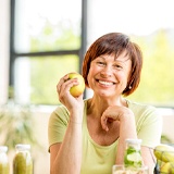 smiling woman holding an apple