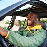 Man smiles outdoors