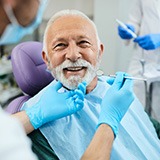 Dental implants save you money by not needing to be replaced frequently like dentures and bridges