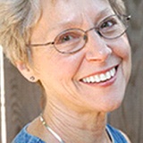 Older woman with shorter hair smiling