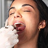 Woman with brown hair receiving a dental exam