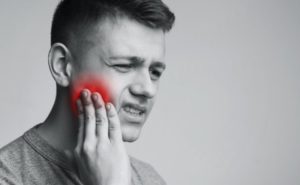 man suffering from toothache in monochrome photo