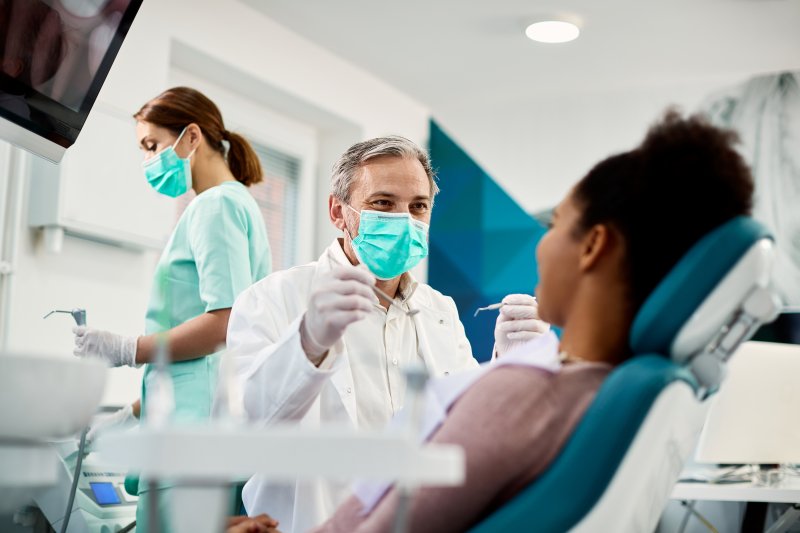 Dentist talking with patient during a dental checkup