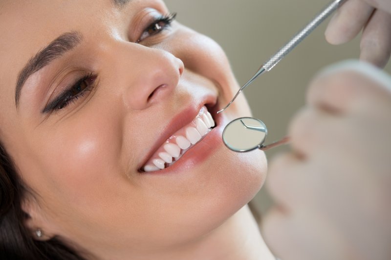 a woman having her mouth examined