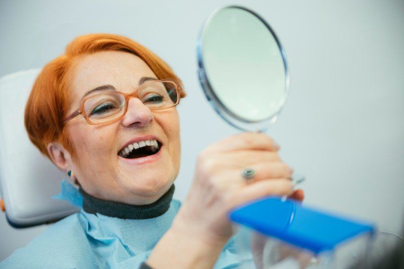 Smiling patients wearing dentures