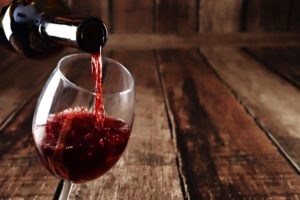 Glass of red wine on rustic table