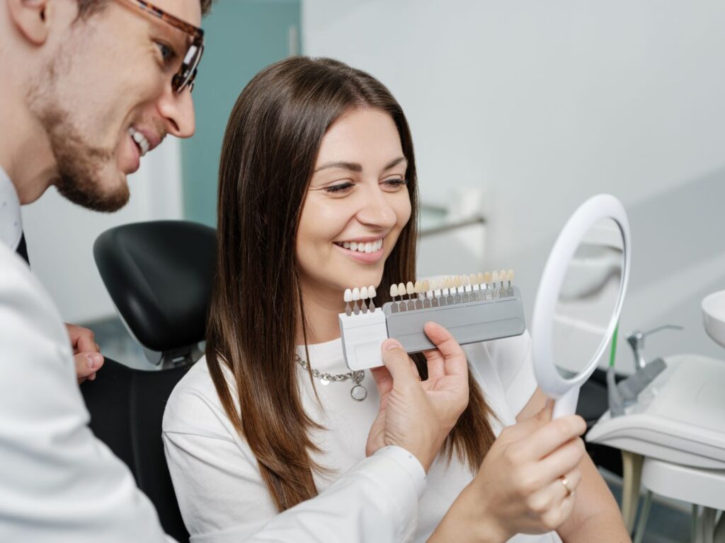 A woman selecting veneers at the dentist