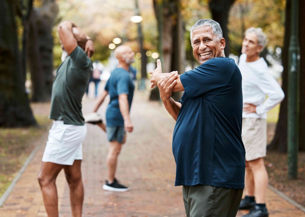 Men stretching at a park